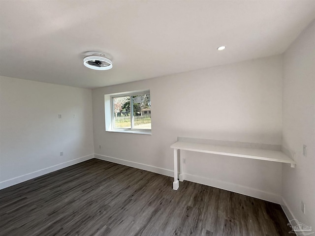 empty room with dark hardwood / wood-style floors