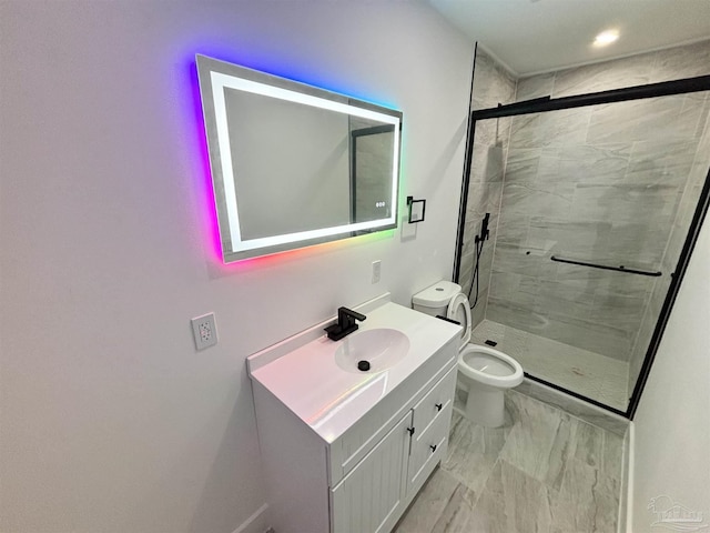 bathroom with vanity, toilet, and a shower with shower door