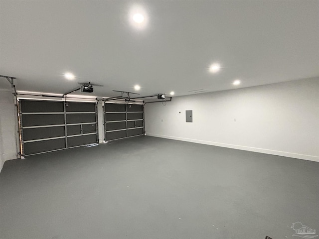 garage with a garage door opener and electric panel