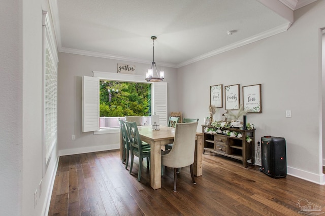 dining space featuring dark wood finished floors, a chandelier, ornamental molding, and baseboards