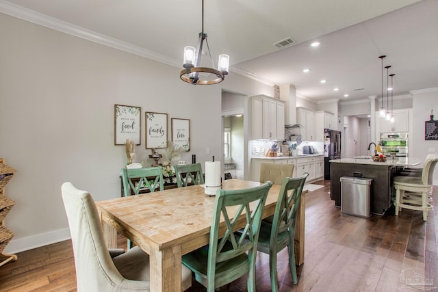 dining space with ornamental molding, a chandelier, dark wood-style flooring, recessed lighting, and baseboards
