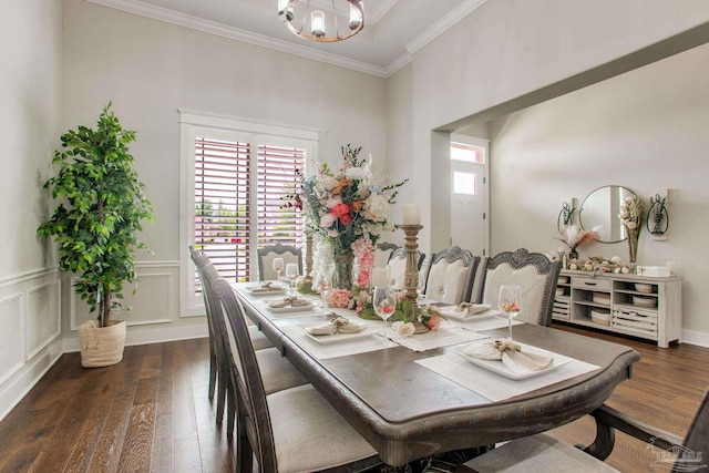 dining space featuring hardwood / wood-style flooring, crown molding, and a chandelier