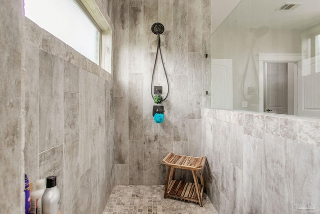 full bath with tiled shower