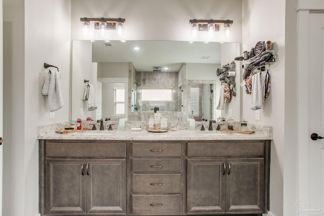 full bath with a shower stall and double vanity
