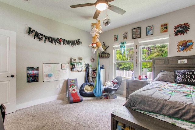 carpeted bedroom with baseboards and a ceiling fan