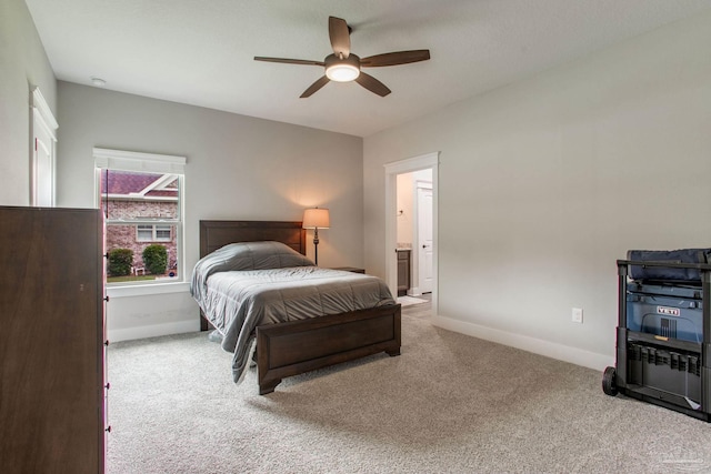 bedroom with carpet floors, baseboards, ceiling fan, and ensuite bathroom