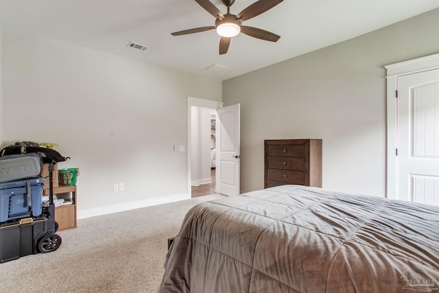 carpeted bedroom with ceiling fan and baseboards