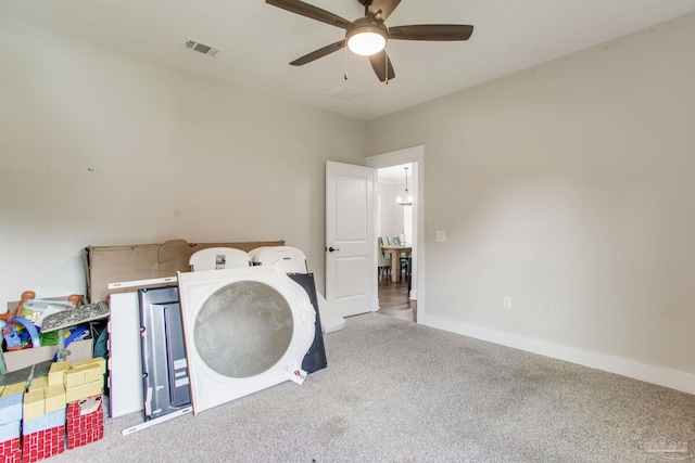 laundry area featuring ceiling fan, carpet flooring, and baseboards