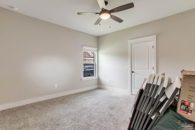 unfurnished room with carpet floors, baseboards, ceiling fan, and a smoke detector