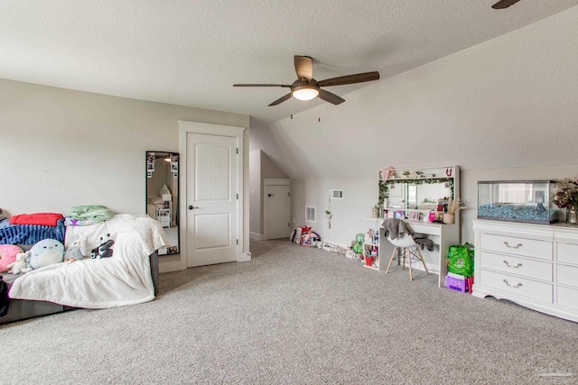 carpeted bedroom with lofted ceiling, a textured ceiling, and a ceiling fan