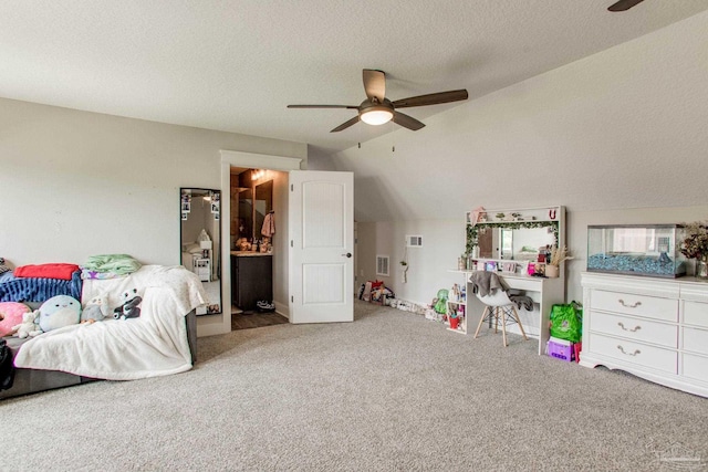 carpeted bedroom with lofted ceiling, a textured ceiling, and ceiling fan