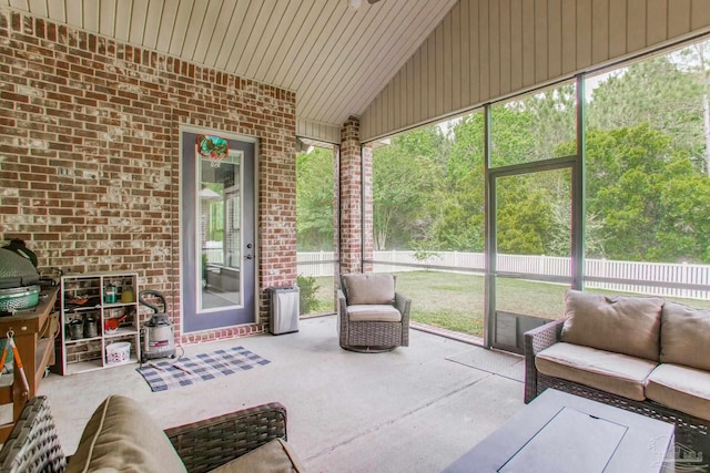 sunroom featuring an outdoor hangout area and lofted ceiling