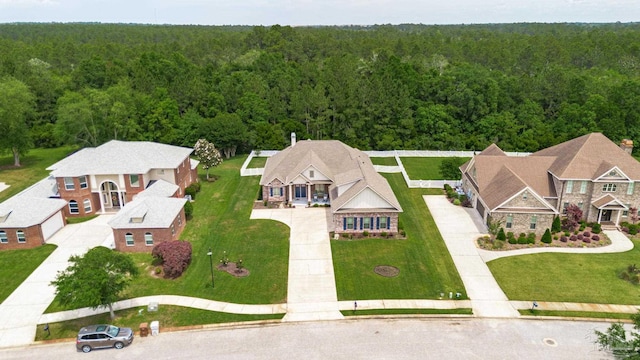 view of subject property with a heavily wooded area