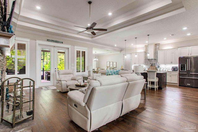 living room with a ceiling fan, a raised ceiling, dark wood-style floors, recessed lighting, and ornamental molding