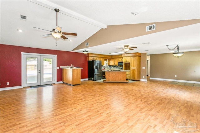 kitchen featuring stainless steel fridge, ceiling fan, visible vents, and open floor plan