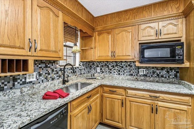 kitchen featuring light stone counters, decorative backsplash, and black appliances