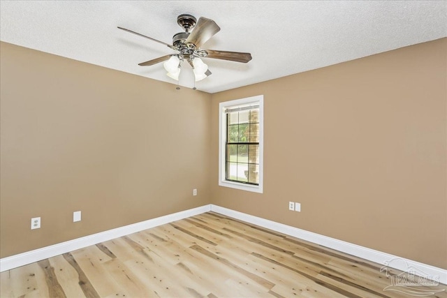 empty room with baseboards, ceiling fan, and light wood-type flooring