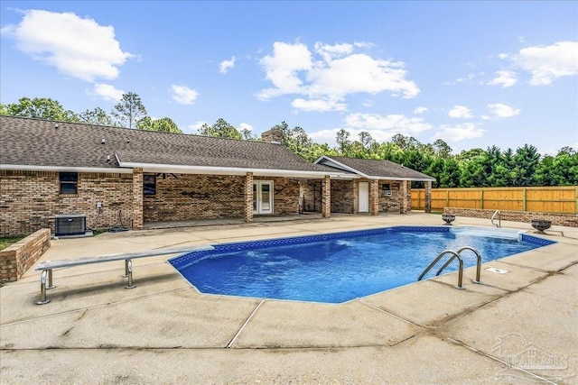 view of swimming pool with fence, a fenced in pool, a patio, and cooling unit
