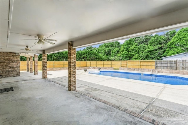 view of swimming pool featuring a fenced backyard, a ceiling fan, and a patio area