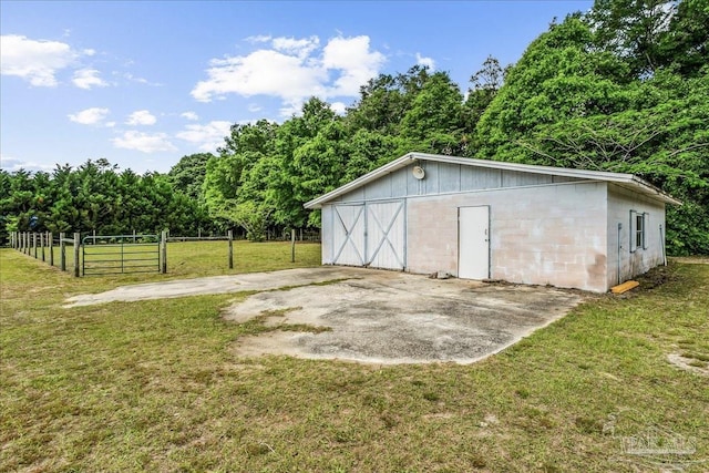 view of outdoor structure featuring fence and an outdoor structure
