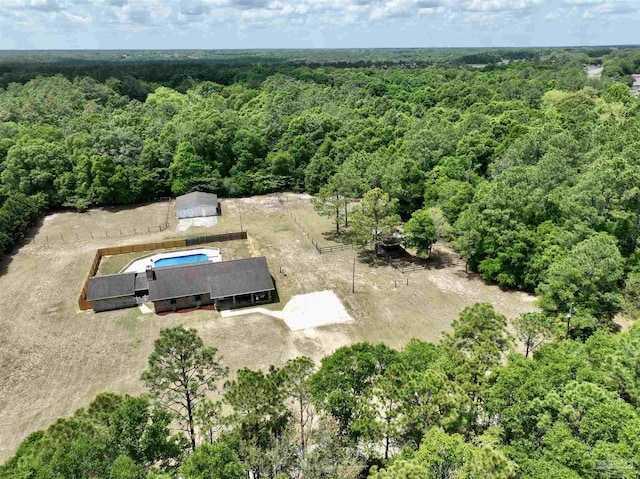 birds eye view of property featuring a wooded view