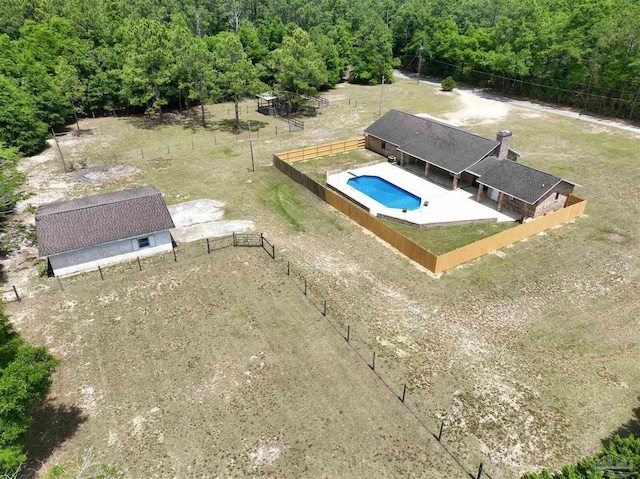 bird's eye view with a wooded view