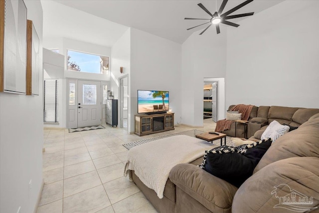 tiled living room featuring high vaulted ceiling and ceiling fan