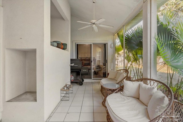 sunroom with ceiling fan and lofted ceiling