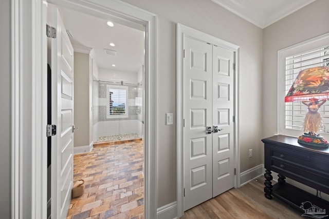 hallway with crown molding, brick floor, baseboards, visible vents, and recessed lighting