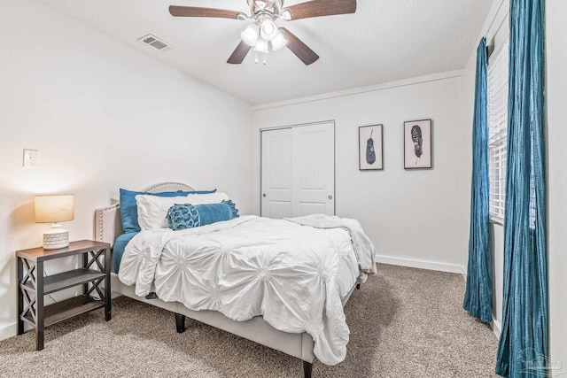 bedroom featuring ceiling fan, a closet, and carpet