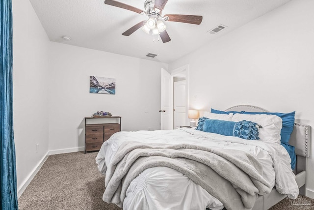 bedroom featuring carpet flooring, ceiling fan, and a textured ceiling