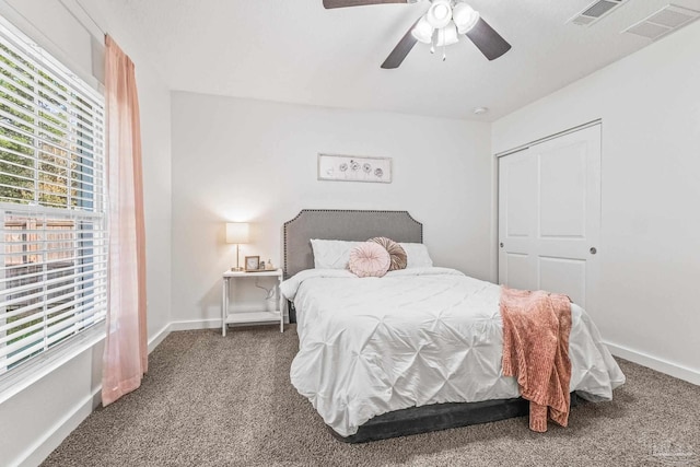 carpeted bedroom featuring ceiling fan and a closet