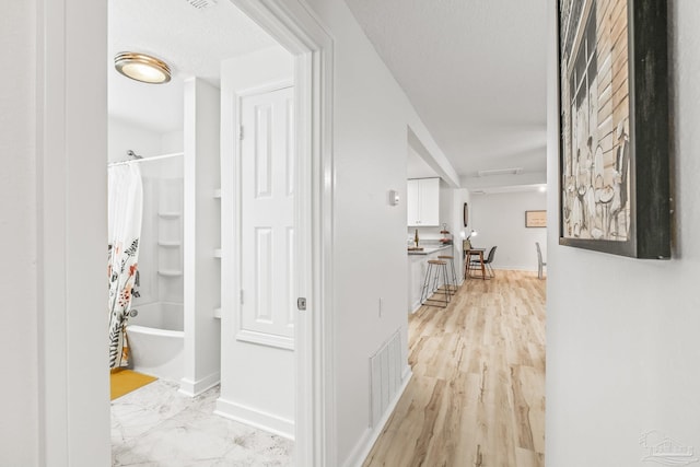 hallway featuring light hardwood / wood-style flooring