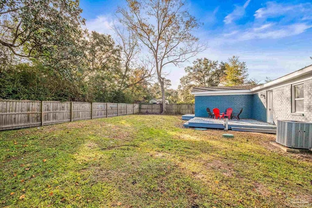 view of yard featuring a wooden deck and central AC