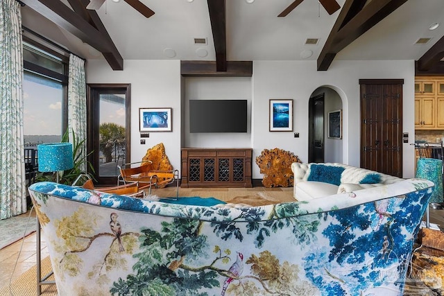 3063 Bay St, Gulf Breeze, FL 32563 - living room with ceiling fan, beamed ceiling, arched walkways, and tile patterned flooring