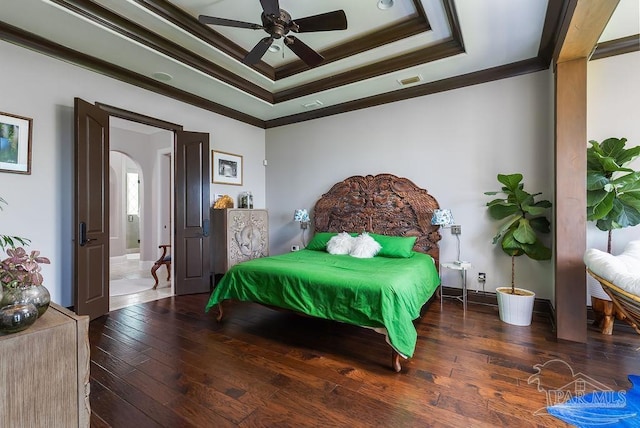 3063 Bay St, Gulf Breeze, FL 32563 - bedroom with a tray ceiling, crown molding, wood-type flooring, arched walkways, and baseboards
