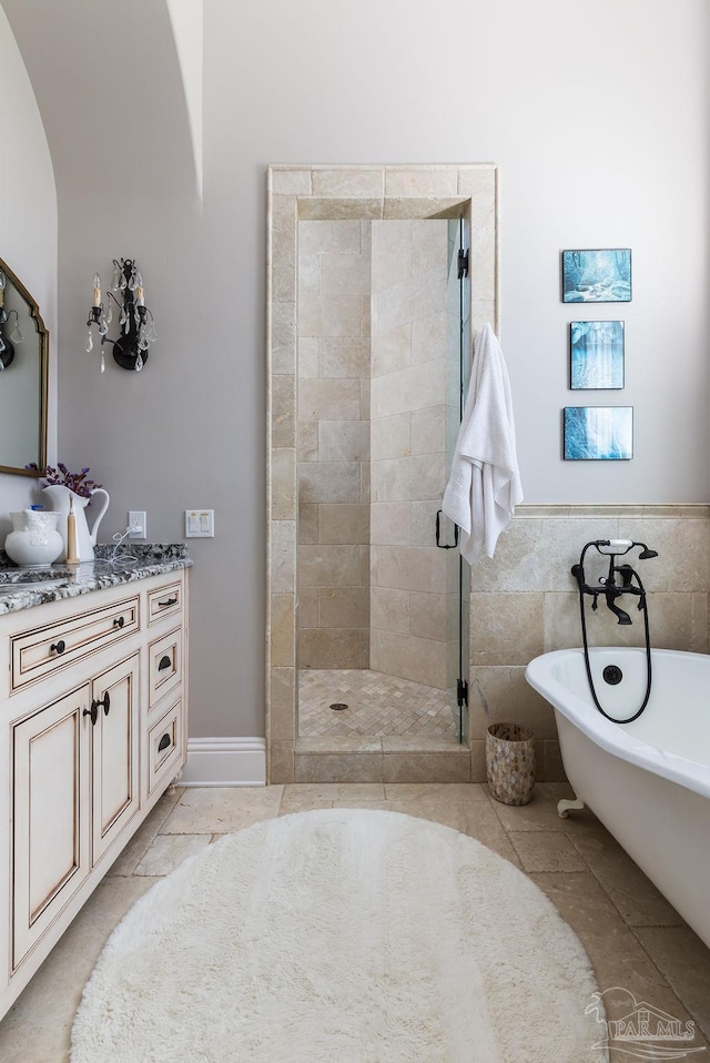 3063 Bay St, Gulf Breeze, FL 32563 - bathroom featuring a stall shower, a soaking tub, vanity, tile walls, and tile patterned floors