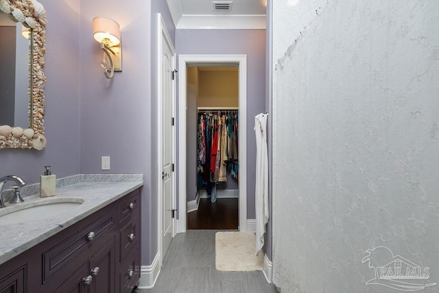 3063 Bay St, Gulf Breeze, FL 32563 - bathroom featuring vanity, baseboards, and a spacious closet