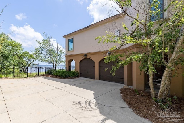 3063 Bay St, Gulf Breeze, FL 32563 - view of property exterior with driveway, stucco siding, and a garage