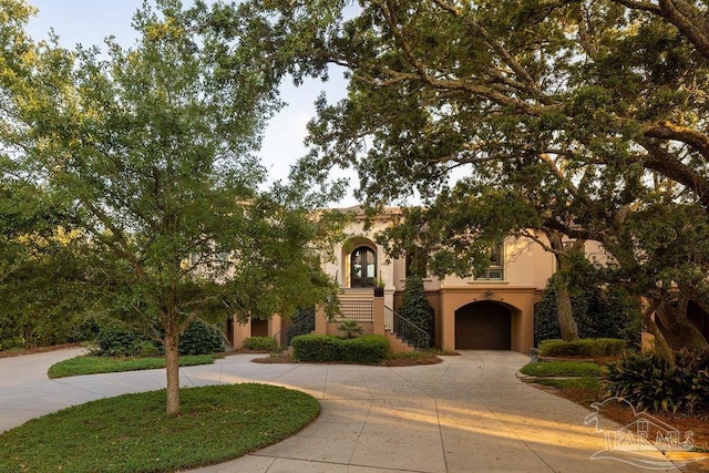 3063 Bay St, Gulf Breeze, FL 32563 - view of front facade featuring stairs, stucco siding, and curved driveway