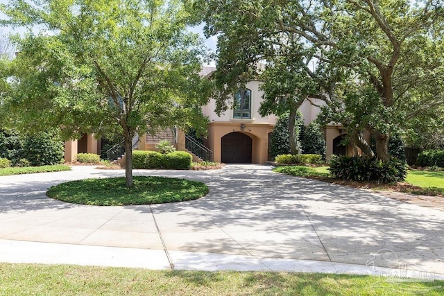 3063 Bay St, Gulf Breeze, FL 32563 - view of front facade with curved driveway, stairway, stucco siding, and an attached garage