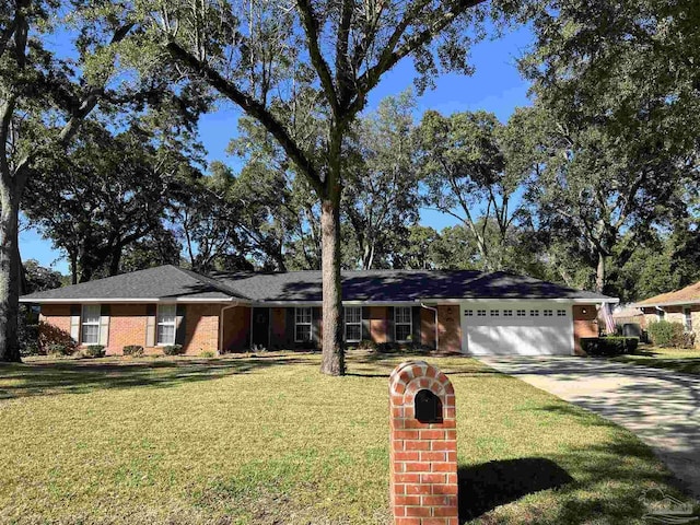 ranch-style home featuring an attached garage, brick siding, driveway, and a front yard