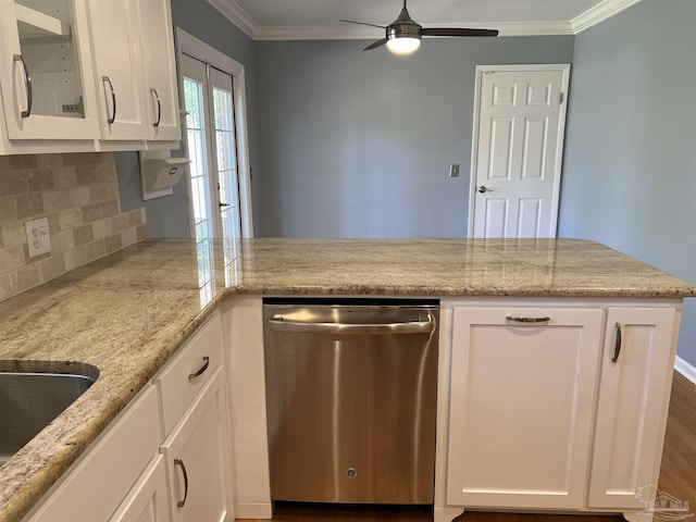 kitchen with light stone counters, backsplash, stainless steel dishwasher, ornamental molding, and white cabinets