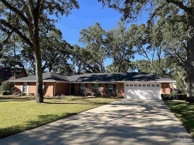 single story home with an attached garage, a front lawn, concrete driveway, and brick siding