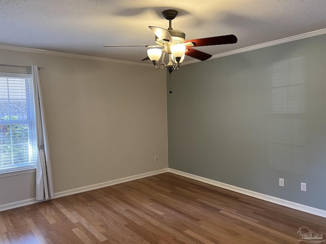 empty room featuring dark wood-type flooring, crown molding, and a textured ceiling