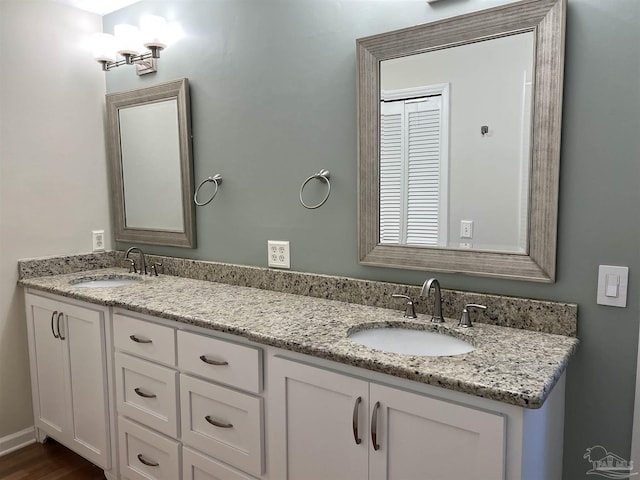 bathroom featuring double vanity and a sink