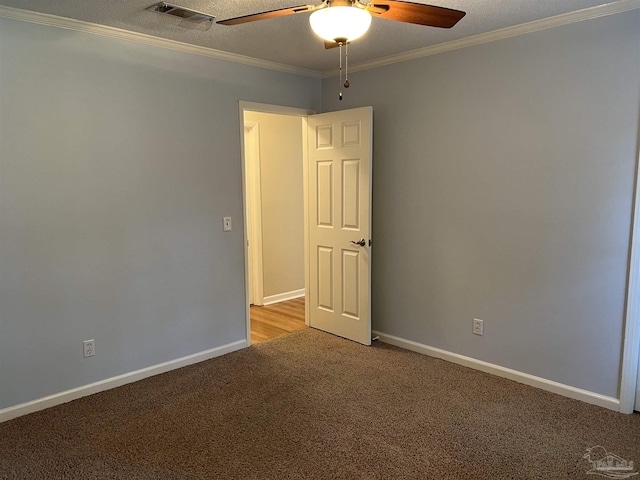 spare room with baseboards, visible vents, ornamental molding, and light colored carpet