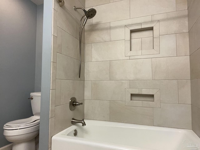 bathroom with toilet and bathtub / shower combination