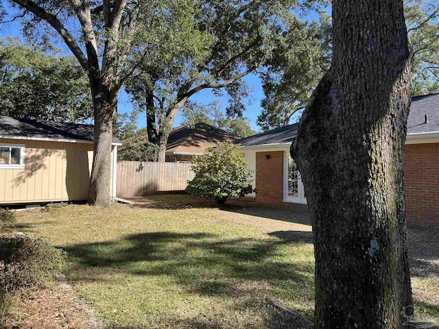 view of yard with an outbuilding and fence