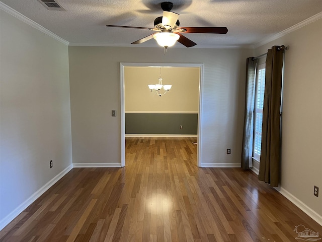 spare room with ornamental molding, a textured ceiling, and wood finished floors